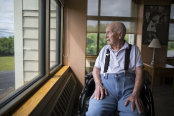 man looking out a window